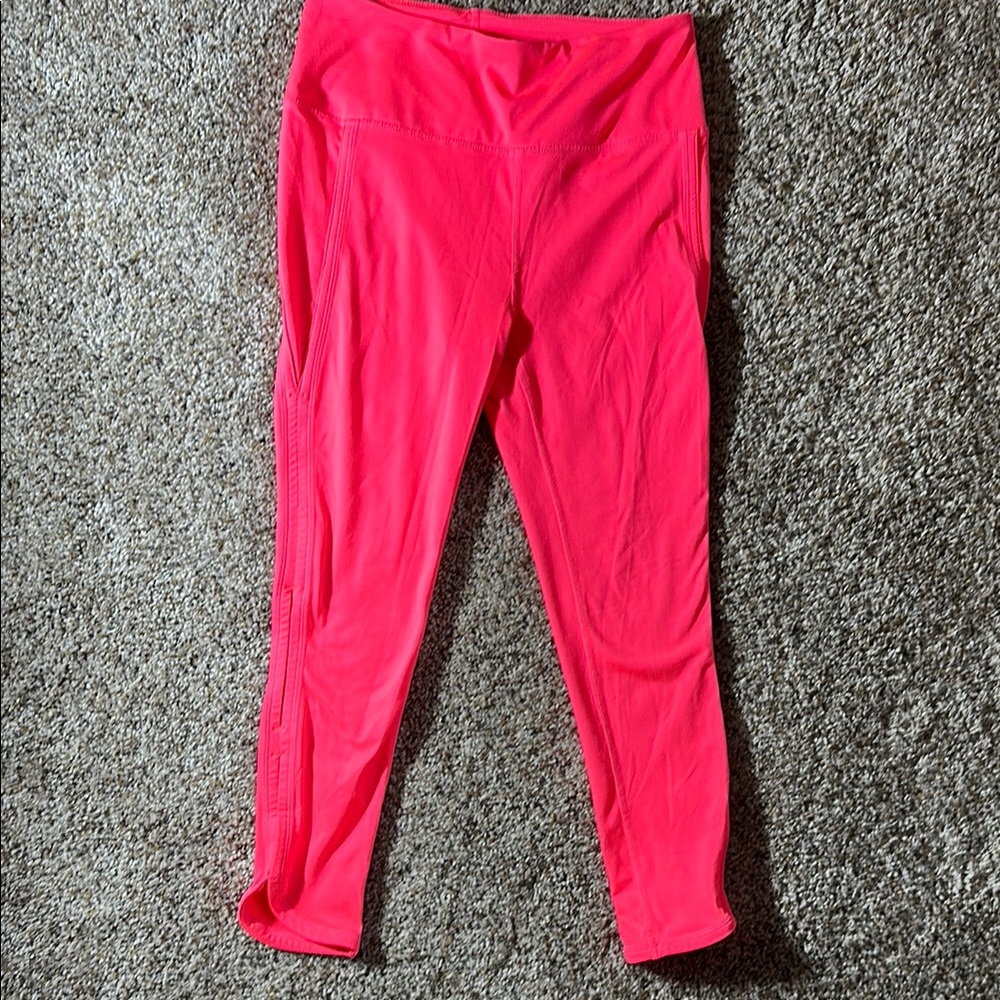 Free People hot coral 7/8 leggings with cute peek-a-boo leg. Size S.